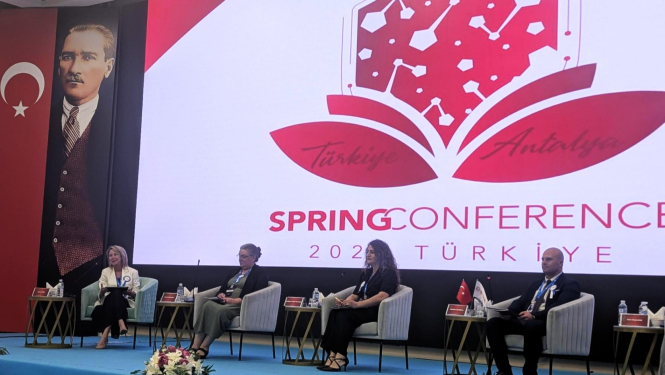Panel discussion at the Spring Conference 2024 in Antalya, Türkiye, with speakers seated on stage in front of a large conference screen