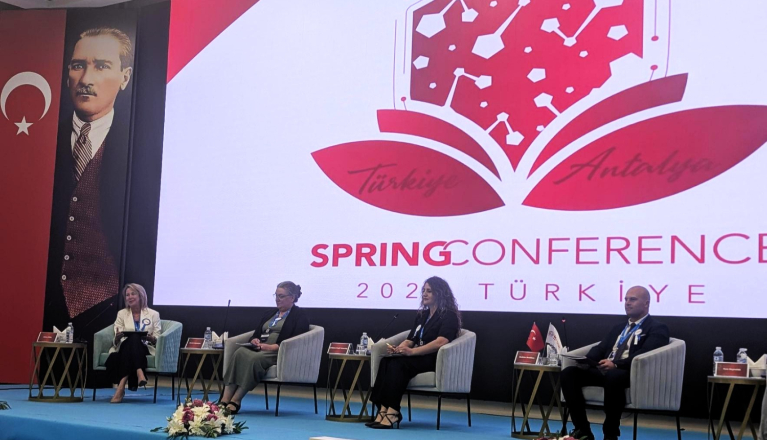Panel discussion at the Spring Conference 2024 in Antalya, Türkiye, with speakers seated on stage in front of a large conference screen